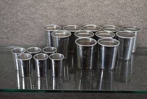 lot 2184 image: Set of 17 Aluminum Cups  6 Shot Glasses and 11 Small Drinking Cups  Marked with a Knight Helmet -WILL SHIP