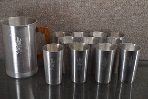lot 2185 image: Lot of 12 Aluminum Housewares  Pitcher 7 38 Tall with Wood Handle  11 Drinking Cups 4 78 Tall  Marked with a Bundle of Wheat -WILL SHIP