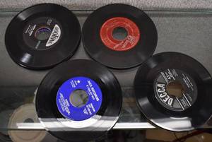 lot 2196 image: Approximately 25 7 45 RPM Vinyl Records  Songs Include Smokin In The Boys Room by Motley Crue, Play That Funky Music by Wild Cherry & More -WILL SHIP