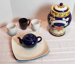 lot 2026 image: Large Ceramic Biscotti Jar, Blue Tea Pot(slight chip on spout), 11 12 in. Square Lifted Corner Platter and 3 Corelle Stoneware Mugs