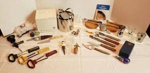 lot 2047 image: Bar Service Items  SS Small Ice Bucket from Denmark, Bar Utensils, Wine Bottle Coasters, Shot Glasses, Cork Pullers, and Decorative Cork Stoppers