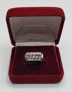 lot 1006 image: 14K Gold Ring with approximately 12 Karat of Baguette Diamonds. Center row is Round Cut Tanzanite stones. Local Jeweler gave retail estimate of $3,000.00  Size 8, 7.5g TW