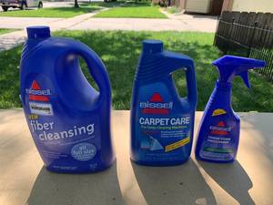 lot 2399 image: Thre Bissell Carpet Cleaning Chemical Bottles - Large Bottle is Mostly Full, others are more than half gone
