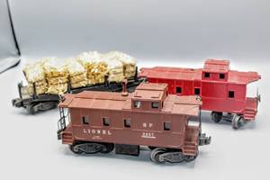 lot 4226 image: Lionel Train O Scale Trains (3), SP 2357 Caboose, Unmarked Caboose missing Smokestack and Brake Wheels, and Automatic Lumber Car Hauling Hay 3461