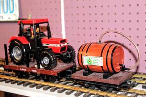 lot 4280 image: LGB Lehmann Hauling Cars, 94569 Carrying an International tractor and Barrel of Seit Fahrhunderten der Besondere im Backsbeutel-Frankenwein G Scale