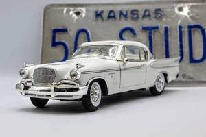 lot 4324 image: 1957 Studebaker Die Cast Model and A License Plate which reads 50 STUD