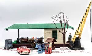 lot 4360 image: Assorted Lot of Lionelville Depot, Lionel Railroad Crossing Light, (4) Vending Machines, Lionel 252 Crossing Gate, 1955 Ford Thunderbird 94228, Couple Figurines, Wishing Well, Tree and (2) Utility Poles and a couple additional surprises