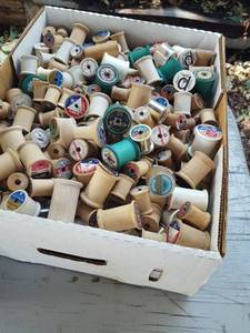 lot 6264 image: Box of thread spools. Most are wood