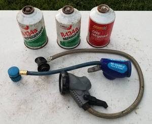 lot 4108 image: 3 cans of R-134a refrigerant and two gauges
