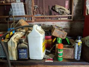 lot 1116 image: Contents Of Table, 2 12 Gallon Gas Can, Saws, And More