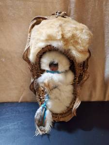 lot 8658 image: Native American Baby Wrapped in Fur in. Wicker Basket.Wall Hanger