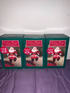 lot 8707 image: Set of 3 Hallmark Santa Claus Stocking Hangers Basement Closet