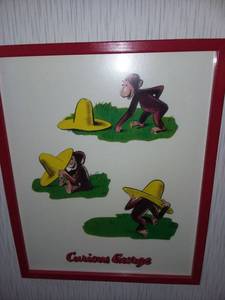 lot 1249 image: Curious George Framed Art in Red Frame 21 x 17 in