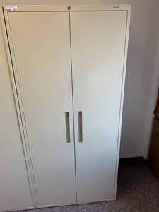 lot 2817 image: Tall two door storage cabinet