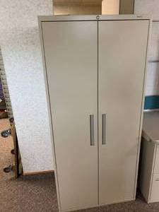 lot 2828 image: Tall two door storage cabinet
