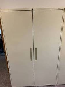 lot 2816 image: Tall two door storage cabinet