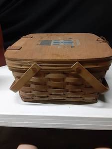 lot 8317 image: Longaberger Handwoven Medium Basket with Handles and Lid with Decorative Design on Top