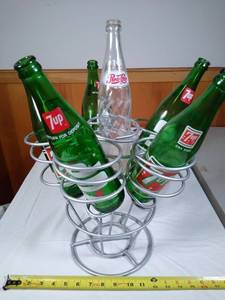 lot 87 image: Wine bottle holder with vintage glass soda bottles
