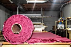 lot 6239 image: This Lot Contains (1) Large Roll of Stretch Velvet Fabric in Wine Color 54, Roll measures 10.5 Diameter