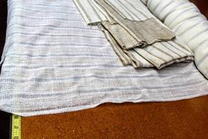 lot 6241 image: (1) Large Roll of Light Weight Fabric Striped White and Light Blue, and a Couple Yards of Coordinating Striped Tan