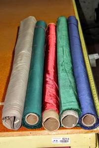 lot 6219 image: This Lot Contains (5) 56 and 48 Rolls of Solid Sheen Fabrics in Blue, Greens, Red, TanTaupe