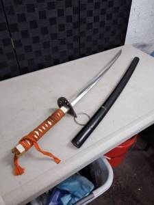 lot 1430 image: orange and white cloth handled sword