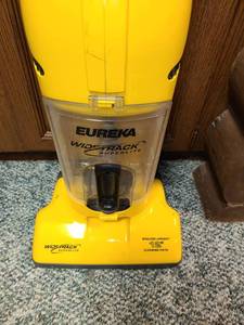 lot 1002 image: Eureka WideTrack 12 Bagless Upright. With a few Accessories