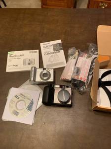 lot 2100 image: The Canon PowerShot camera and the Olympus digital camera