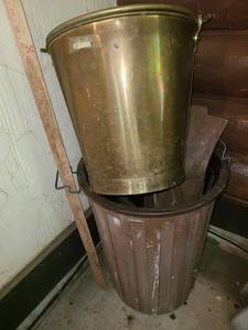 lot 5023 image: 20 tall plastic trash can and a metal trash can 13.5 tall. The larger can has scrap wood pieces inside