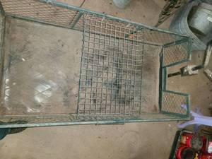 lot 5028 image: Metal Gardening Cart. 25 x 48 x 23 A Tire is flat. You may want to bring air bubble so it can be easily moved