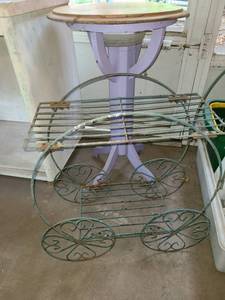 lot 5034 image: 2 Plant Stands. 1 Wooden Pedestal is 27 tall x 14. and metal 25 tall x 28 wide x 10 deep