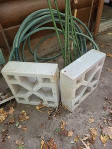 lot 5105 image: 20 Gallon GOTT Trash Can, Garden Hose, 6 ..6FT. Garden Stakes, and 2 decorative Cement Blocks