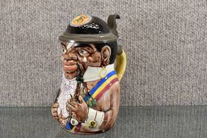 lot 1315 image: Vintage Black Fraternity German Student Beer Stein  Geschutzt Circa late 1800s.  12 Liter