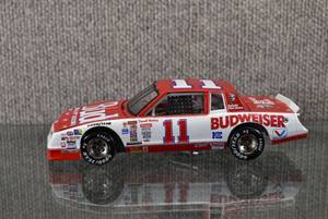 lot 1381 image: Vintage Action 1985 Darrell Waltrip #11 Budweiser KFC Monte Carlo  124 Scale  All Tires Roll, Front Tires Turn  8 x 3