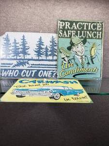 lot 1596 image: Lot of 3 Funny Metal Adult Metal Signs  Car Wash, Who Cut One, Practice Safe Lunch