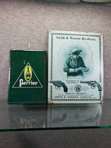 lot 1606 image: Lot of 2 Smith & Wesson & Perrier Metal Signs  Various sizes