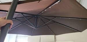 lot 4322 image: 10 Patio Umbrella. 7 Tall, Extends 5 Out. Shown As Is. Missing Base Connector And Electronic Controller
