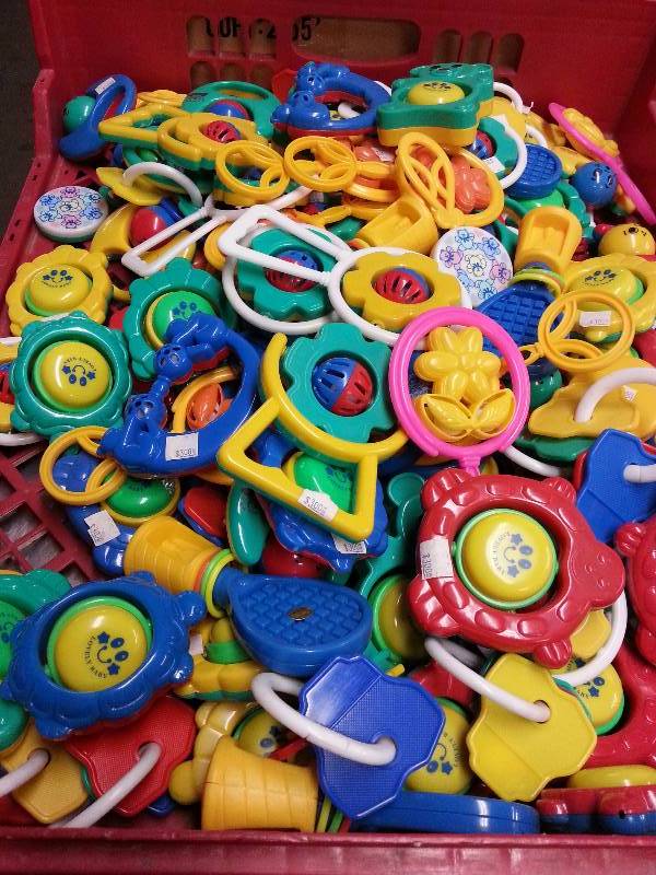 lot 1037 image: 10 lbs. box of plastic baby rattles and toys