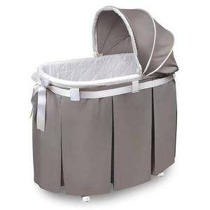 lot 61181 image: Badger Basket Wishes Oval Bassinet, Full Length Skirt, White Bedding