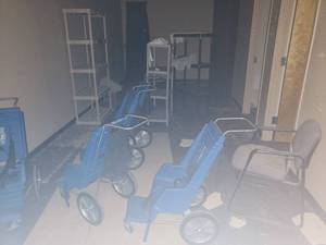lot 6072 image: Contents of area - 5 strollers, storage shelves