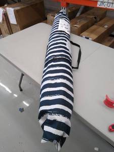 lot 5084 image: Qipi blue an white umbrella. ( size UNKNOWN.). Tilts.