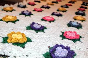 lot 5062 image: Colorful Crocheted Afghan with Three Dimensional Roses, Pink Blue Yellow and Purple, Measures 61 x 49