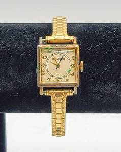 lot 5046 image: Vintage Womens Bulova Watch 10K GF Top Caps, Engraved with date 51044 - Speidel stretch wrist band.