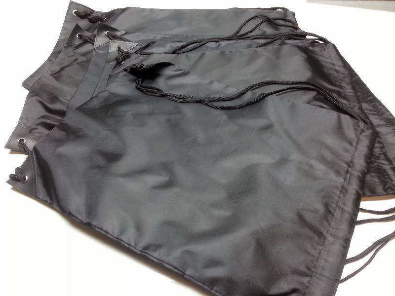lot 1181 image: 7 total HD Black Nylon pull string back packs book carriers in this auction lot or for a big lunch on the job.
