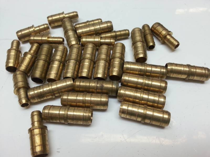 lot 1248 image: Assortment of new brass rubber hose couplers for fuel line or vacuum hose fittings.