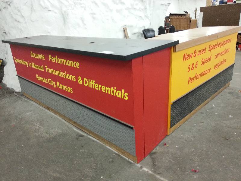 lot 1271 image: Parts counter reception table with storage shelves with Formica tops Red Black one is 118 X 30.  Yellow one is 84 X 25 and both 42 tall