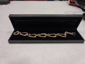 lot 2360 image: 14k 8 31g White and Yellow Gold Textured Oval Ribbon Bracelet