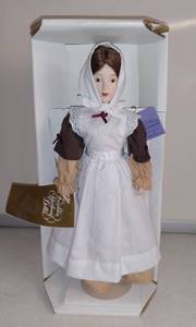 lot 4939 image: Franklin Heirloom Dolls Brown Dress With Apron Doll