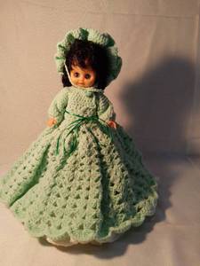 lot 9972 image: Baby Doll with Crocheted Dress and Doll Stand