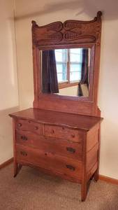 lot 100 image: Antique Oak 4 Drawer Dresser on Casters w Mirror  Dresser 44 x 22 x 35 in. tall & Mirror 41 x 47 in. tall  Mirror is already detached from Dresser